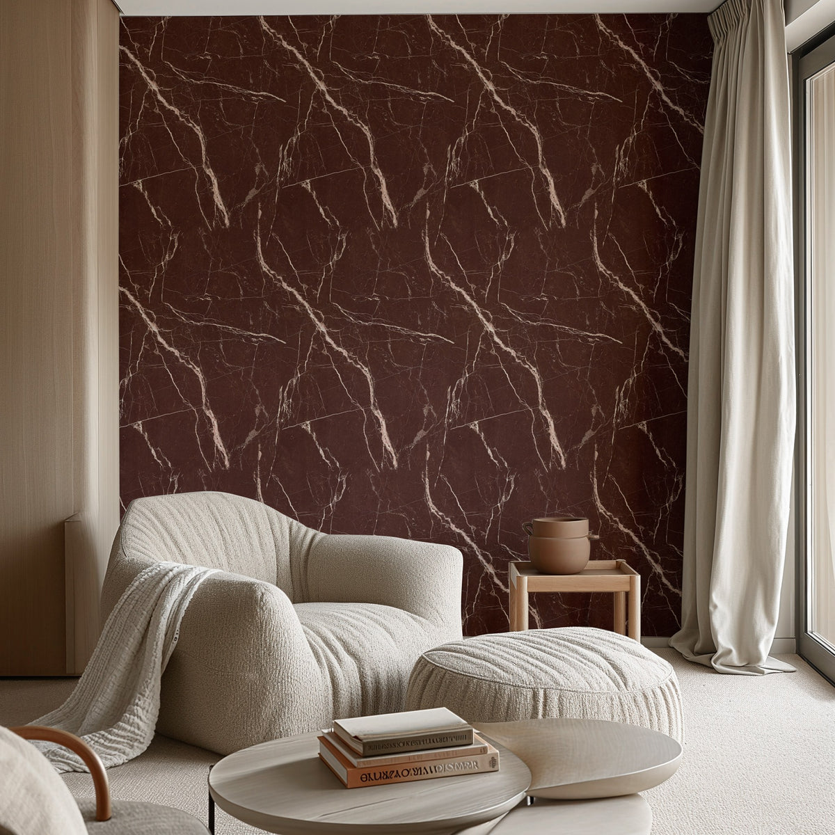 Red Levanto marble wallpaper on a living room wall with a cream armchair