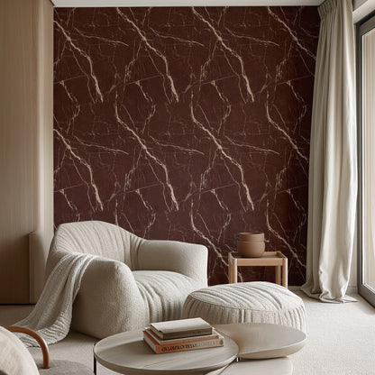 Red Levanto marble wallpaper on a living room wall with a cream armchair
