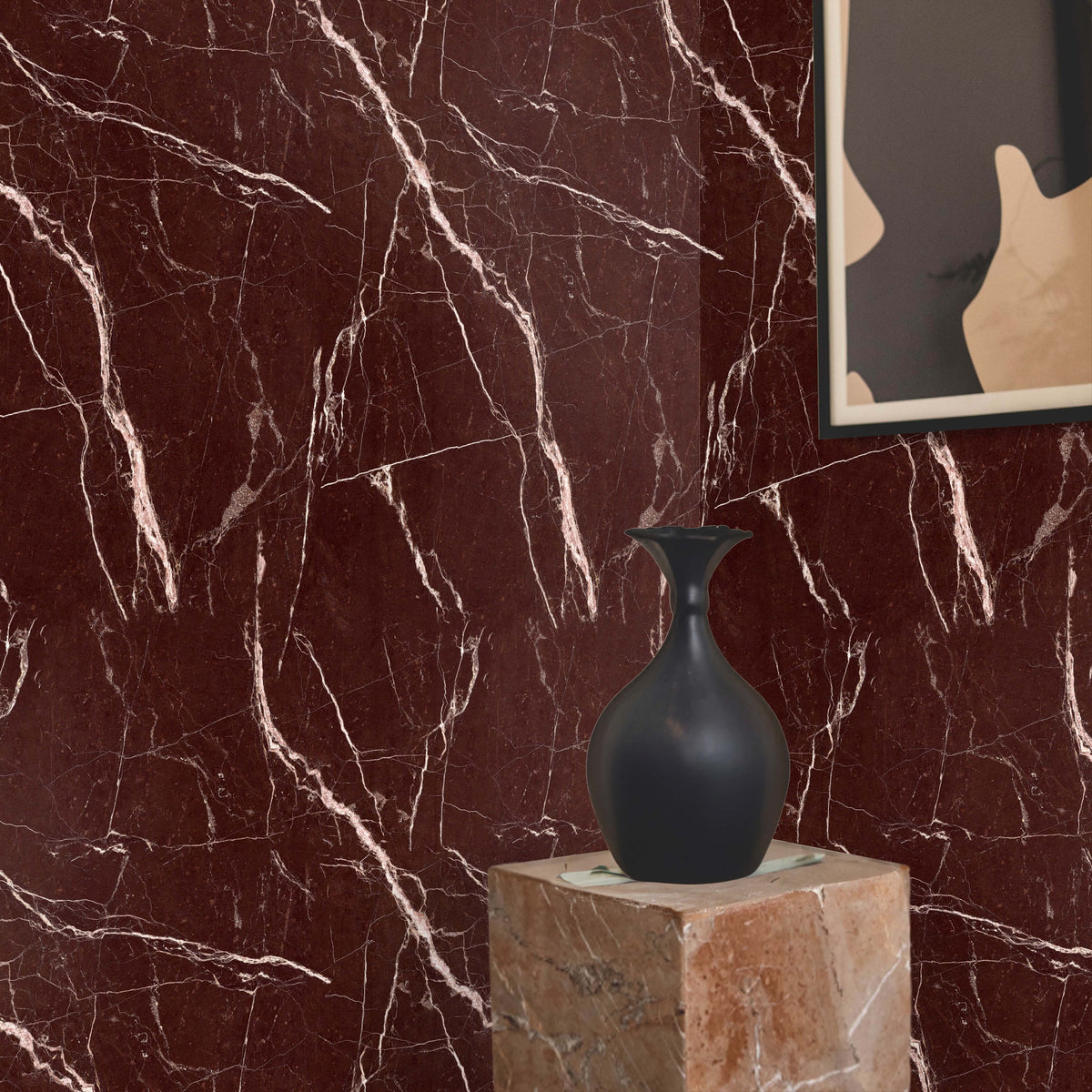 Red Levanto marble wallpaper close-up with a black vase on a stone pedestal